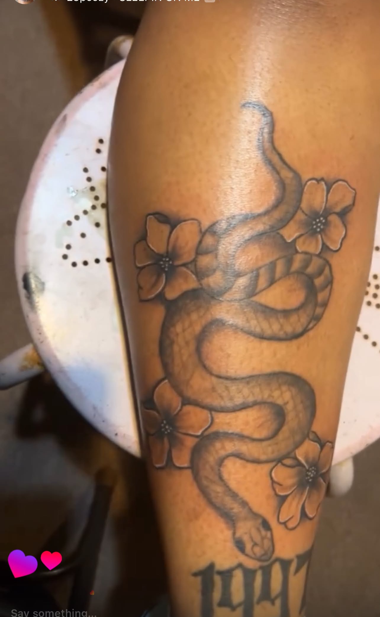 Snake and floral tattoo on forearm